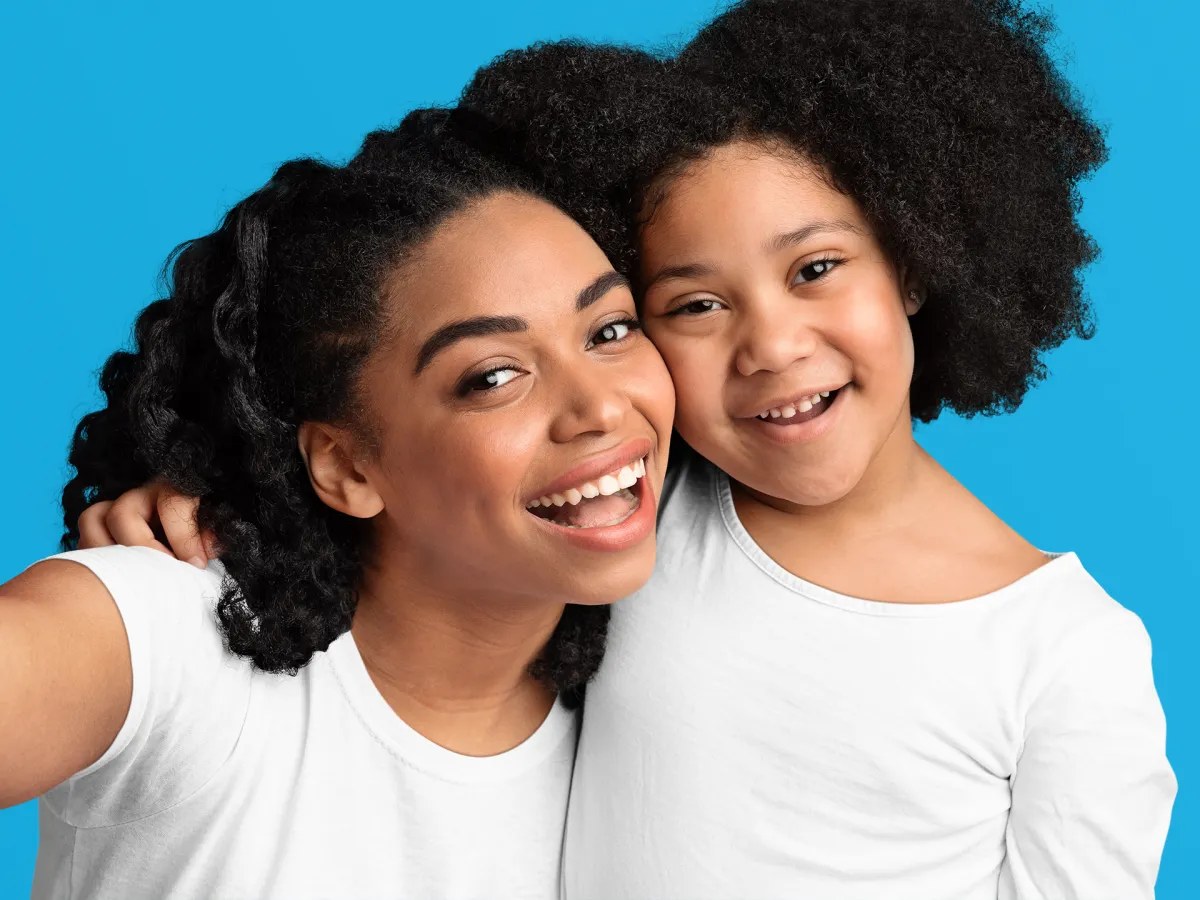 A mother and daughter smiling together